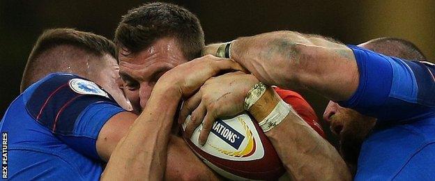 Wales captain Sam Warburton is held up against France