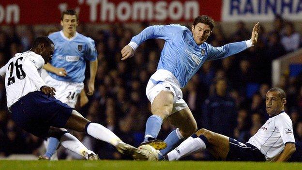 Man City's Jon Macken takes on the Spurs defence, supported by pre-red card Joey Barton