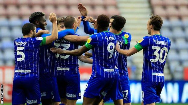 Wigan players celebrate a goal against Stoke