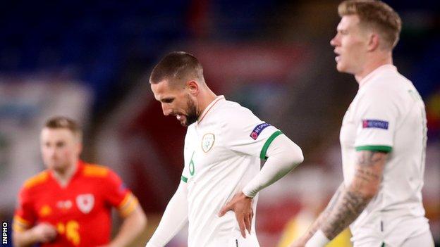 Conor Hourihane (centre) shows his disappointment after Sunday's defeat in Cardiff as team-mate James McClean also walks off the pitch after the final whistle