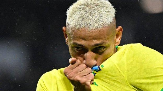 Richarlison kisses the Brazil badge