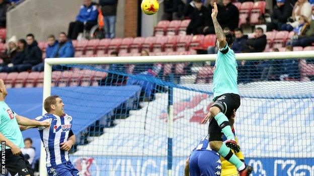 Bradley Johnson heads in