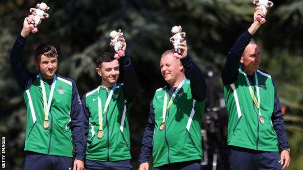 NI men's fours celebrate their win