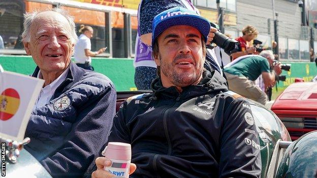 Fernando Alonso sitting in a car