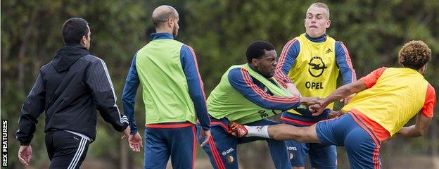 Miquel Nelom fights with Tonny Vilhena as other Feyenoord players and staff look on