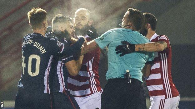 Referee Gavin Duncan tries to separate Hamilton and Ross County p;layers