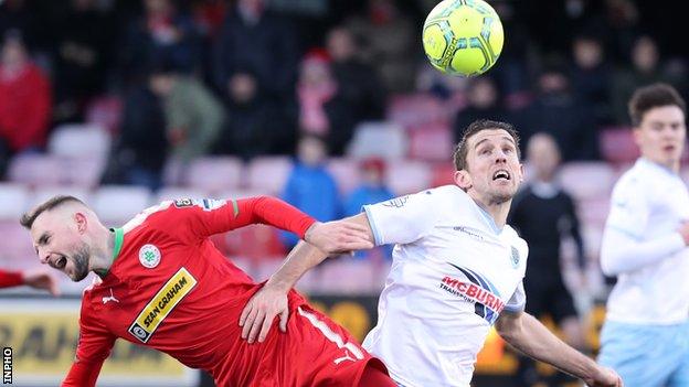Cliftonville midfielder Jude Winchester takes a tumble in this challenge with Ballymena's Gary Thompson