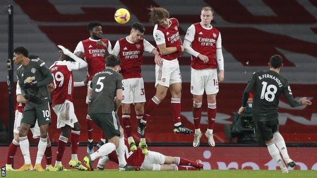 Manchester United's Bruno Fernandes takes a free-kick against Arsenal in the Premier League