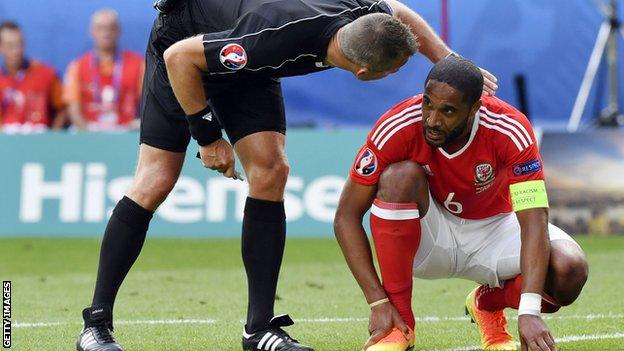 Ashley Williams is injured playing for Wales against Slovakia at Euro 2016