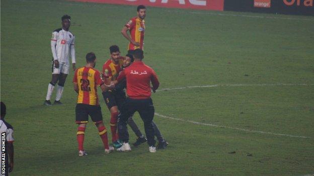 A fan gets on the pitch during the African Champions League semi-final second leg in Tunisia between Esperance and Angola's Primeiro de Agosto