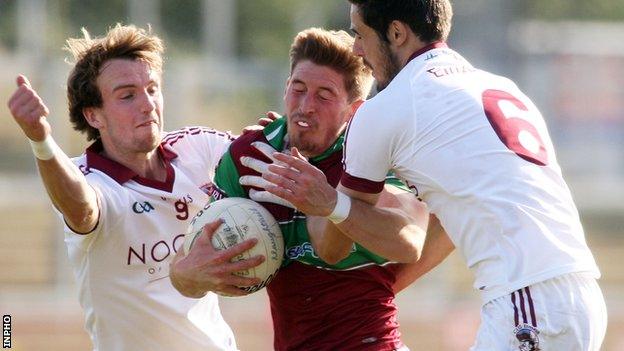 Slaughtneil duo Declan Mullan and Chrissy McKaigue tackle Coleraine's Padraig Cassidy