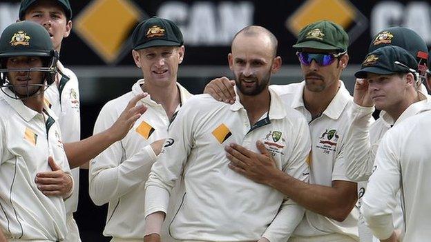 Australia celebrate a wicket by Nathan Lyon (centre)