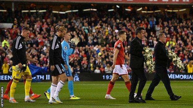 Nottingham Forest and Fulham players walk on to the field before a minute's silence for Queen Elizabeth II