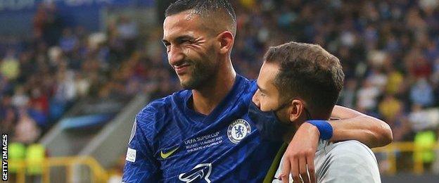 An injured Hakim Ziyech is helped off the pitch