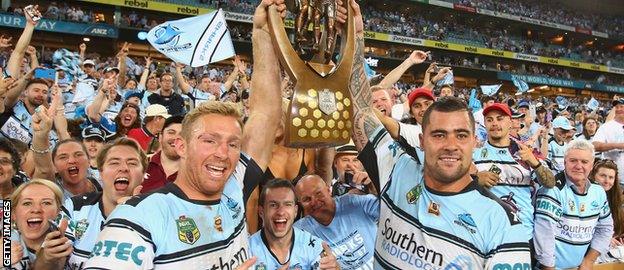 Matt Prior and Andrew Fifita hold the NRL trophy aloft