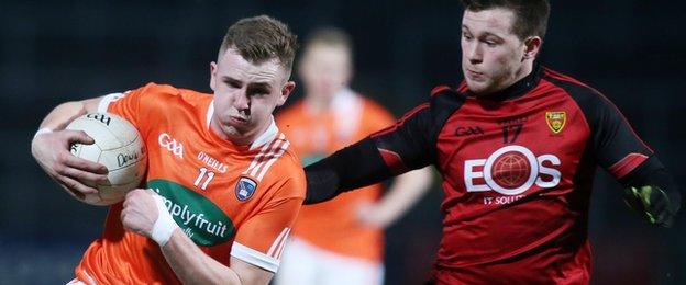 Armagh forward Jack Rafferty attempts to move clear of Down opponent Gareth McDowell