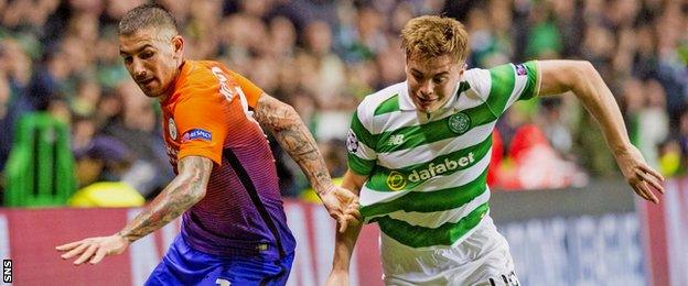 Celtic's James Forrest takes on Aleksander Kolarov