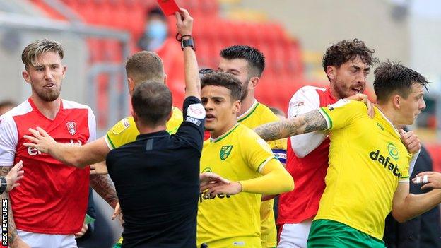 Rotherham defender Angus MacDonald (left) is sent off for a foul on Norwich midfielder Oliver Skipp