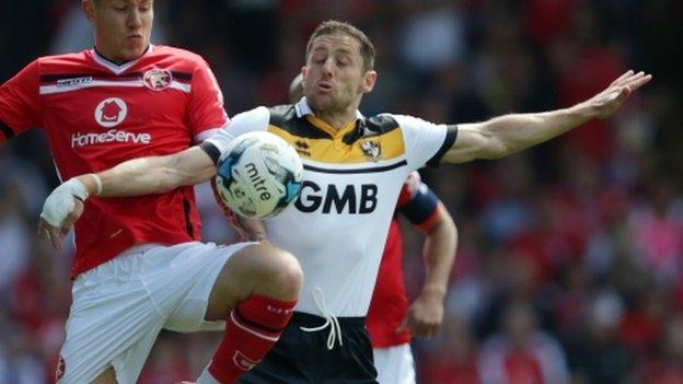 Port Vale midfielder Michael Brown tangles with Walsall's Kieron Morris during the final day of the season 5-0 defeat at Bescot