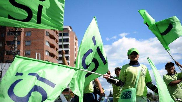 People supporting a referendum initiative backed by Ecuadorean President Rafael Correa wave flags sporting the word "Yes" in Quito on 4 May 2011.