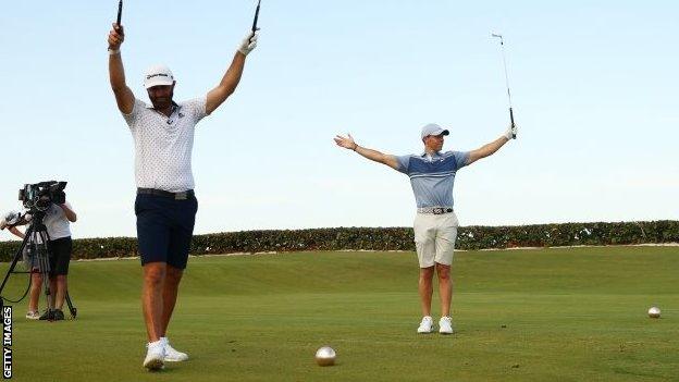 Dustin Johnson and Rory McIlroy celebrate winning the charity skins match in Florida