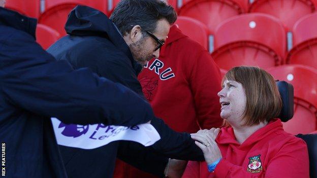 Kerry Evans with Wrexham co-chairman Ryan Reynolds at the Racecourse Stadium.