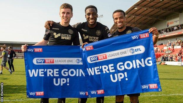 Wigan players celebrate winning promotion