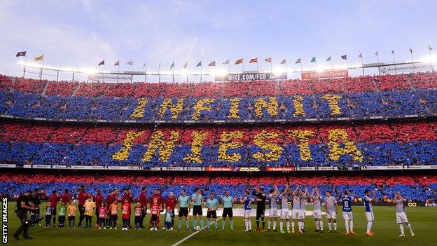 A mosaic message reading 'Forever Iniesta' formed by the Barcelona fans