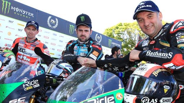 The top three of Derek McGee, winner Michael Dunlop and Michael Rutter after the Supertwins race