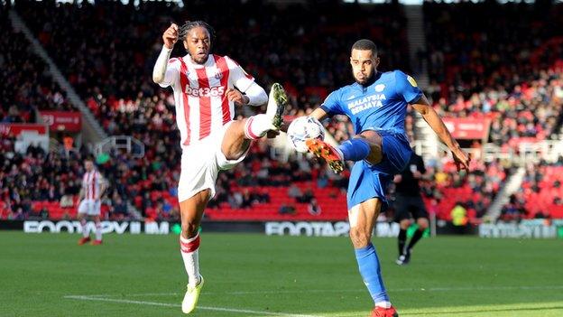 Romaine Sawyers challenging for the ball against Cardiff's Curtis Nelson