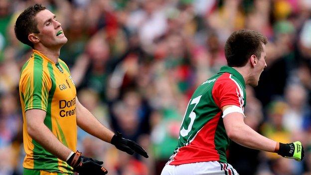 Donegal's Declan Walsh shows his frustration as Cillian O'Connor celebrates one of Mayo's four goals in the 2013 All-Ireland quarter-final