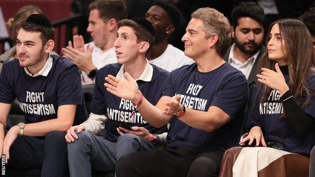 Fans at the Brooklyn Nets game wear 'Fight Anti-Semitism' T-shirts