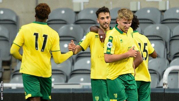 Adam Phillips celebrates scoring a penalty for Norwich City in Premier League 2