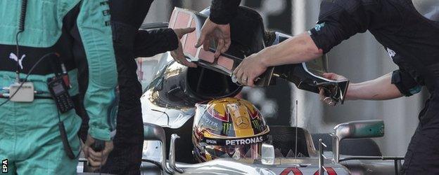 Lewis Hamilton has his headrest replaced in Baku