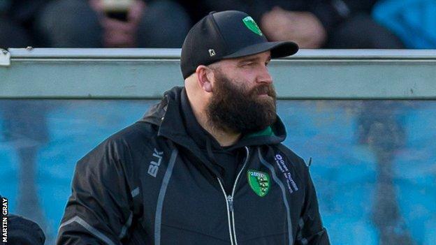 Jordan Reynolds looks on from the sidelines at Footes Lane