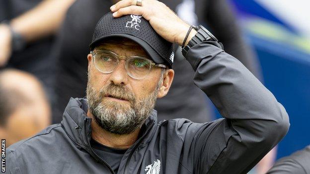 Jurgen Klopp with his hand on his head, wearing an LFC baseball cap