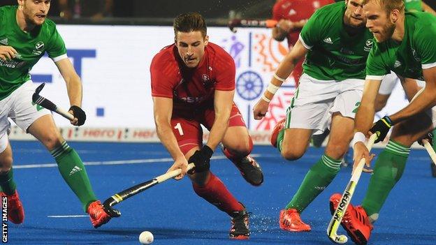 England hockey player Liam Ansell goes to control the ball as Ireland's Conor Harte tries to tackle him during England's 4-2 win over Ireland at the World Cup