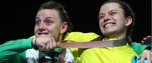 NI's Michaela Walsh with a cheeky grab at the gold medal won by her opponent Skye Nicolson