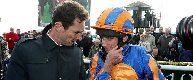 Trainer Aidan O'Brien talks to winning jockey Ryan Moore after Order of St George's Irish St Leger win