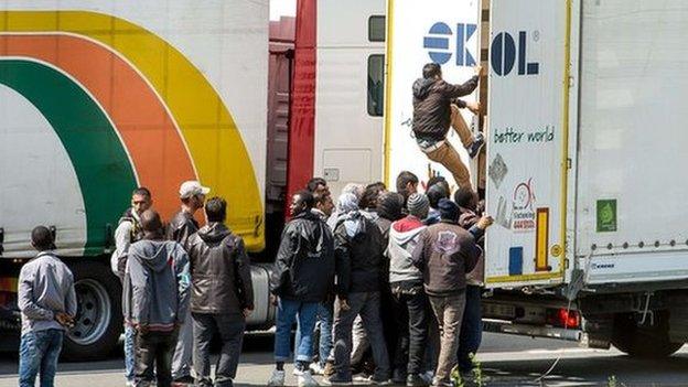 Immigrants getting into a lorry