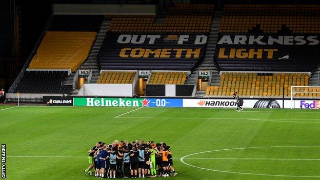 Wolves players and officials celebrate beating Olympiakos