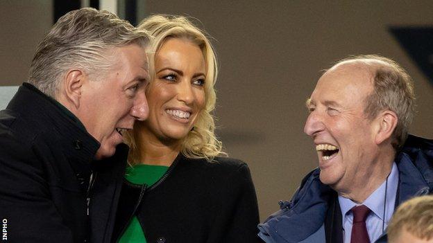 Shane Ross (right) shares a joke with John Delaney and his partner Emma English during the Republic of Ireland's game against Wales last October