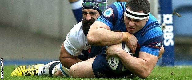 Guilhem Guirado plunges over to score the first try for France