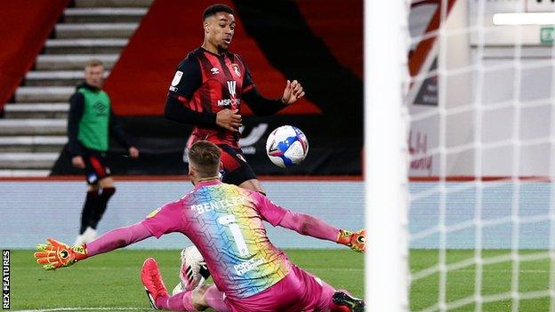 Arnaut Danjuma lifts the ball over Bristol City keeper Daniel Bentley to open the scoring for Bournemouth