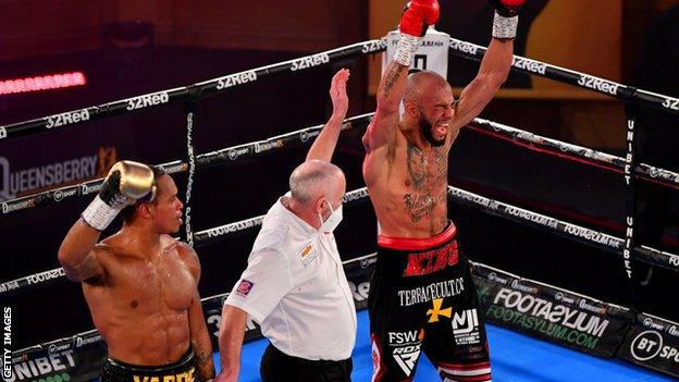 A shocked Anthony Yarde looks at Lyndon Arthur celebrating a scorecards victory