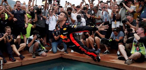 Daniel Ricciardo dives into a pool after winning the Monaco Grand Prix