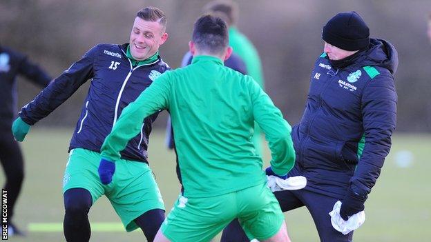 Hibs boss Neil Lennon joins in training with a happy looking Anthony Stokes