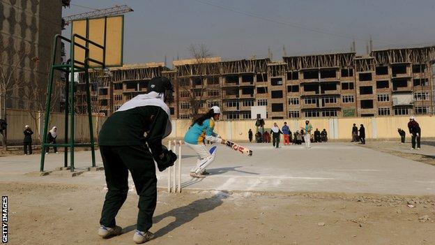 Afghan girls play cricket on the school grounds in Kabul on December 28, 2010