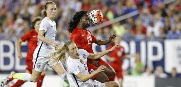 Eniola Aluko battles for the ball against the US