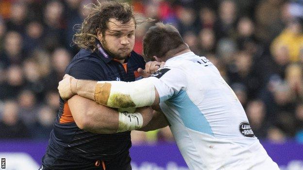 Pierre Schoeman of Edinburgh is tackled by Glasgow's Oli Kebble